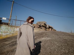 Young woman warm coat back shadow femlens